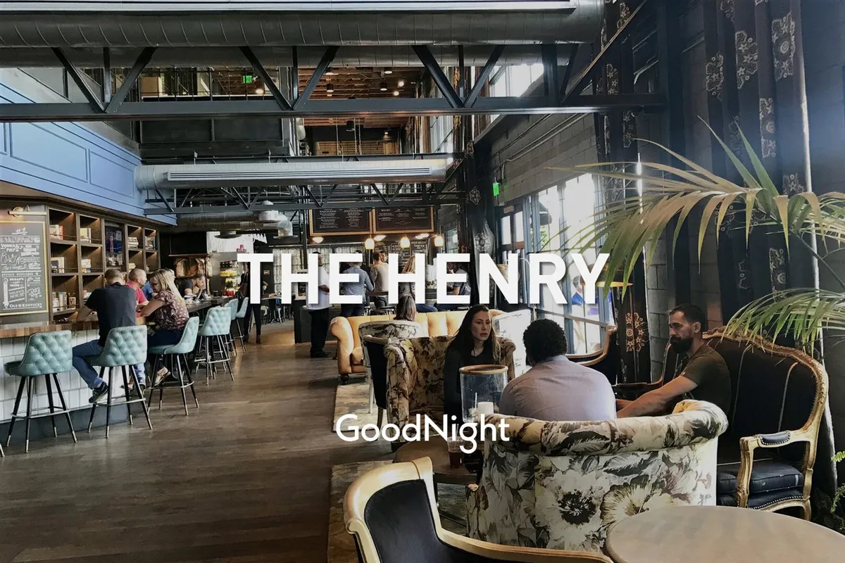 A lively interior bar area with seating, decorative plants, and people socializing over drinks. The space exudes a relaxed, festive mood—ideal for casual meetups and group celebrations after exploring the city.