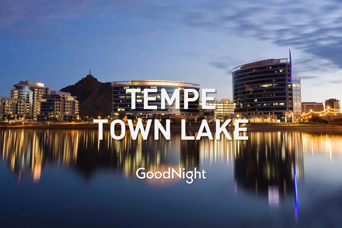 Tempe Town Lake is framed by modern buildings and a mountain backdrop, with a calm water surface reflecting the vibrant sky. The lakeside paths and open space invite leisurely strolls, suggestive of spots where residents and their pets can enjoy peaceful walks.